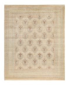 an antique rug with floral design on the center and border in beige, brown and white colors