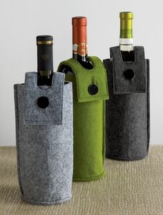 three wine bottles in different colors and sizes