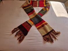 A 10ft Multicoloured Scarf inspired by the 4th Doctor in the Doctor Who Series.  DESIGN This Scarf was worn by the 4th Doctor Who in the Doctor Who series. This scarf can be ordered in any length to suit you. A perfect scarf to keep you warm on those cold winter days.   Other styles of the Doctor Who Scarf can be made to order.  PROCESSING TIMES: The Doctor Who Scarf takes 1-2 weeks processing time and aims to be shipped out to you within 2-3 weeks. (depending on backorders.) Please see my shop announcement to see how long my Processing Time is when you place your order. GIFT IDEAS This Scarf worn by Colin Baker in the Doctor Who Series is an ideal Christmas/birthday present.   WINTER WEAR RANGE To see the rest of the Winter wear range, why not follow the following link: https://www.etsy.c Doctor Who Scarf, Colin Baker, 4th Doctor, Scarf Crochet, Winter Days, Winter Day, Winter Wear, Cold Winter, Birthday Presents