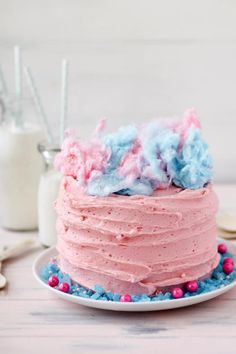 a pink and blue cake on a white plate