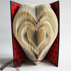 an origami heart shaped box with ribbon