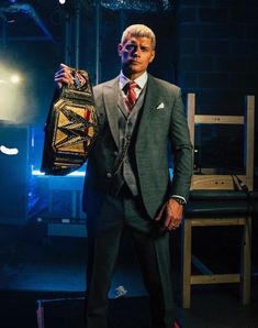 a man in a suit and tie holding a bag