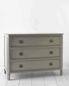 a white dresser sitting on top of a hard wood floor