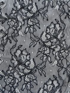 black lace with flowers and leaves on the bottom is seen in this close up photo