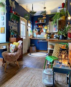 a living room filled with furniture and lots of plants