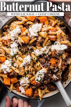 butternut pasta with sausage and goat cheese in a skillet