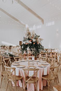 the tables are set with pink and white linens