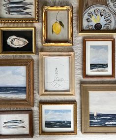 many framed pictures are hanging on the wall with one yellow lemon and two white boats