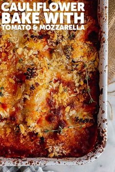 a casserole dish with tomatoes and mozzarella