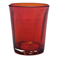 a red glass vase sitting on top of a white table