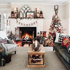 a living room filled with furniture and christmas decorations on top of a fire place in front of a fireplace