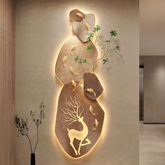 a wall mounted sculpture in the shape of a deer with trees and leaves on it