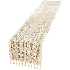 a white table runner with tassels and fringe on it's ends, against a white background