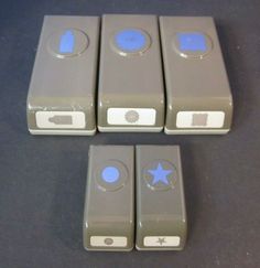 four gray and white buttons with blue stars on them are sitting next to each other