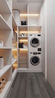 a washer and dryer in a small room with shelves on the wall behind them