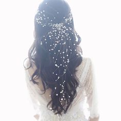 the back of a woman's head with pearls on it