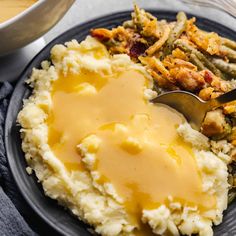 a plate with mashed potatoes and gravy on it