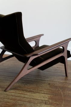 a black chair sitting on top of a wooden floor