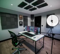 a room with a desk, chair and camera in it