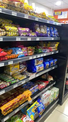 an aisle in a grocery store filled with lots of food and snacks on shelves next to each other