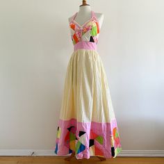 Vintage 1970s maxi dress by Georgia Charuhas, Boutique Las Marioposas, Merida Yucatan Mexico! A gorgeous collectible piece with a patchwork bodice trimmed in lace and a pale yellow pin tucked skirt edged with a deep band of quilted patchwork. The border has  padding for extra volume. Halter tie straps; back zip. 100% cotton. In very good condition, very clean and strong. Dress has one stain as shown on the skirt hem area; there are loose threads and some minor fraying to a few of the patchwork p Pink Patchwork Maxi Dress, Vintage Multicolor Patchwork Dresses, Retro Cotton Maxi Dress, Patchwork Dress Pattern, Merida Yucatan Mexico, Patchwork Dresses, Outstanding Outfits, Quilted Dress, Patchwork Clothes