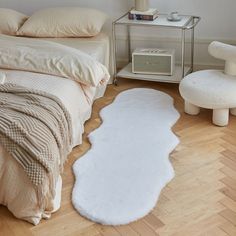 a white rug on the floor in a bedroom