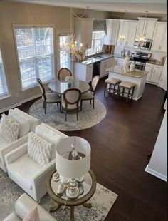 an aerial view of a living room, dining room and kitchen area in a home