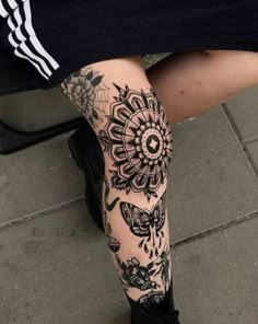 a woman's legs with tattoos on them