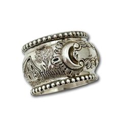 a silver ring with an ornate design on it