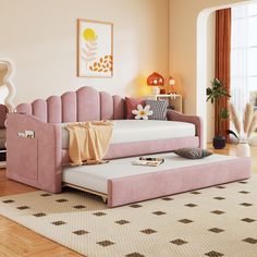 a living room with a pink couch and ottoman