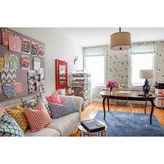 a living room filled with lots of colorful pillows