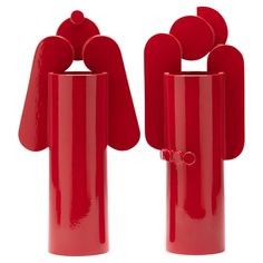 two red vases sitting next to each other on top of a white surface,