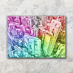 a multicolored photo of buildings in different colors on a white background with grey concrete