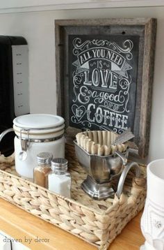 a basket filled with coffee and cookies next to a chalkboard that says, all you need is love