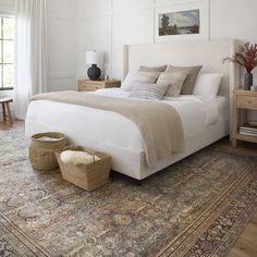 a large bed sitting on top of a wooden floor