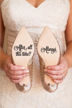 a bride holding her wedding shoes that say i will love you and never