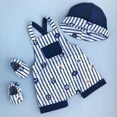 a blue and white striped outfit with matching hat, mittens, and booties