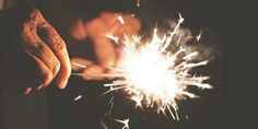 a person holding a sparkler in their hand