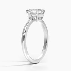 a close up view of a diamond engagement ring on a white background with the center stone in