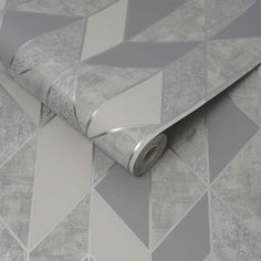 a grey and white wallpaper with an abstract design on the bottom half of it