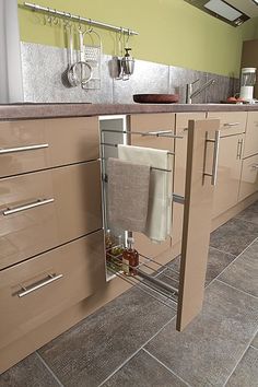 a kitchen with brown cabinets and white towels