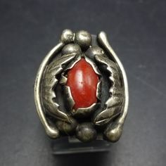 VINTAGE CORAL RING DESCRIPTION:  This exquisite ring features a cab of old red Mediterranean coral set in heavy gauge sterling silver. Applied leaves and raindrops flank the gemstone, and a band a twisted sterling silver wire bisects the split shank band. This fabulous ring will be a cherished addition to your collection of quality vintage Southwestern and Native American jewelry. MEASUREMENTS:  Ring face measures 7/8" x 3/4" RING SIZE:  8 1/4 WEIGHT:  8.5 grams SIGNED:  ƎE STERLING:  unmarked, Collectible Red Rings With Polished Finish, Vintage Gemstone Rings For Collectors, Vintage Red Ring For Anniversary, Vintage Red Hallmarked Signet Ring, Collectible Modernist Jewelry Ring, Red Victorian Hallmarked Rings, Red Antique Collectible Jewelry, Vintage Collectible Hallmarked Rings, Vintage Sterling Silver Oval Rings