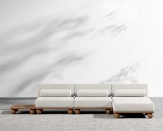 a white couch sitting on top of a wooden table