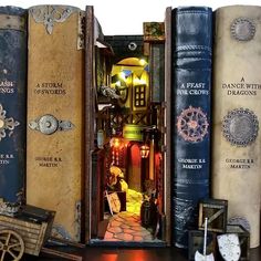 an open book case filled with books on top of a wooden table next to other books