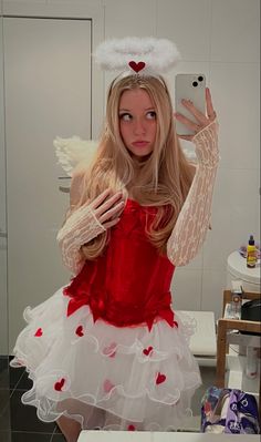 a woman in a red and white dress taking a selfie