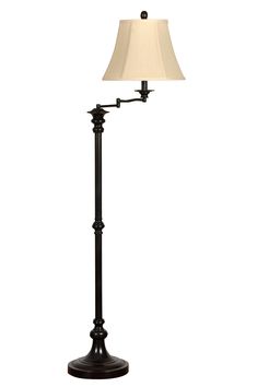 a black lamp with a white shade on it's base and a beige lampshade