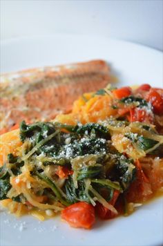 a white plate topped with pasta and vegetables