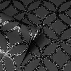 a black and silver wallpaper with circles on the side, in an abstract pattern