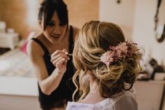 a woman getting her hair done by another woman