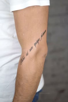 a man with a tattoo on his arm that says, there are quite enough time